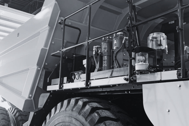 A black and white photo of an AFEX fire suppression system installed on a haul truck