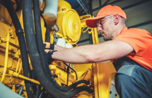 A man performs a pre-shift inspection on his machine's fire suppression system before he gets to work