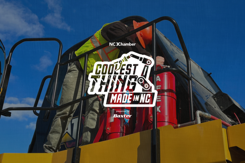 A technician installing a fire suppression system on a haul truck with the logo for NC Chamber's Coolest Thing Made in NC
