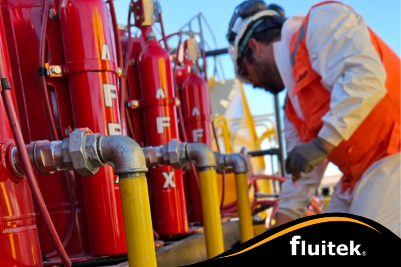 A technician working on a large haul truck, installing AFEX fire suppression systems