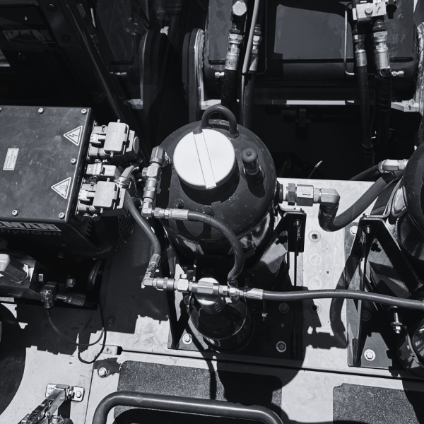 Waste Pro Chooses AFEX Two fire suppression system tanks installed on landfill equipment in black and white